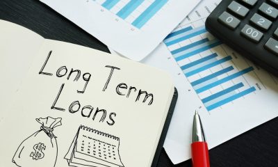 Calculator, bar graphs and note book comprising different types of long term loans